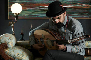 Tawadros plays oud on couch