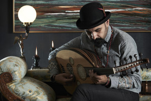 Tawadros plays oud on couch